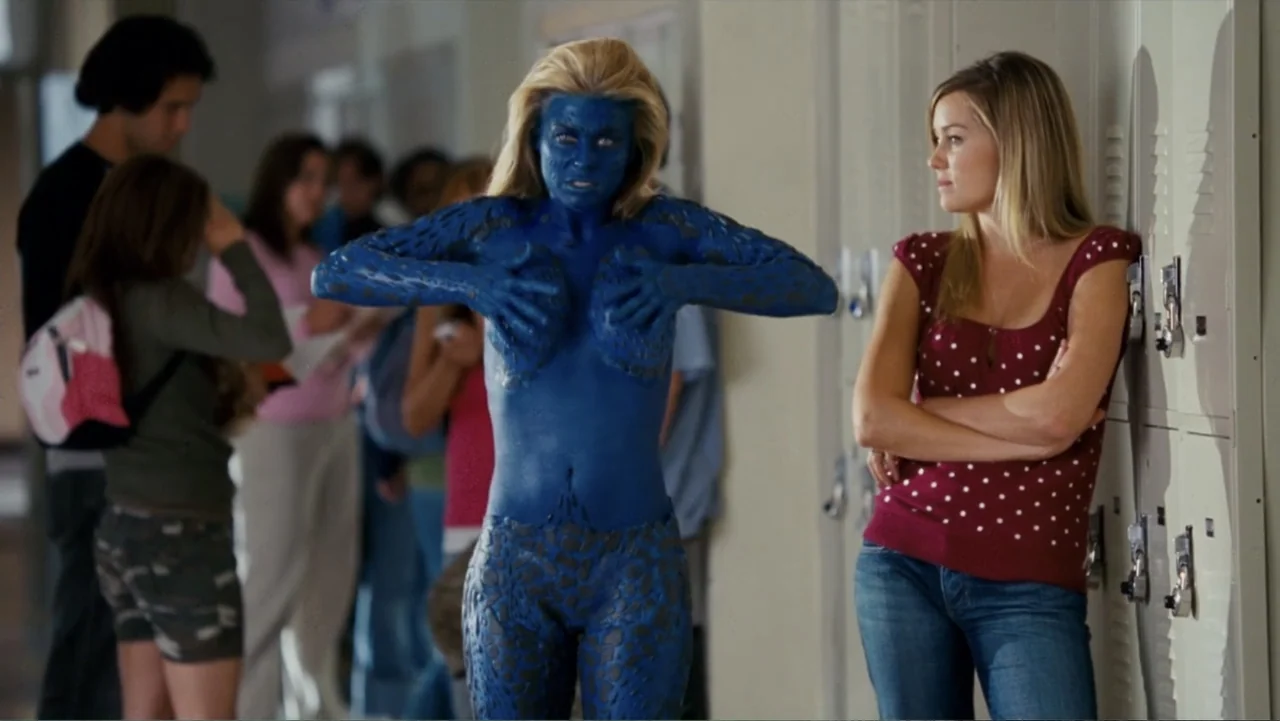 Epic Movie (2007) movie still: fullbody — A brightly lit high school hallway features rows of metal lockers and students. A blue-skinned woman with…
