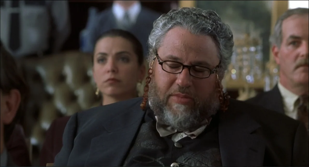 What's the Worst That Could Happen? (2001) movie still: medium — A crowded courtroom interior features wooden benches and rows of seated attendees.…