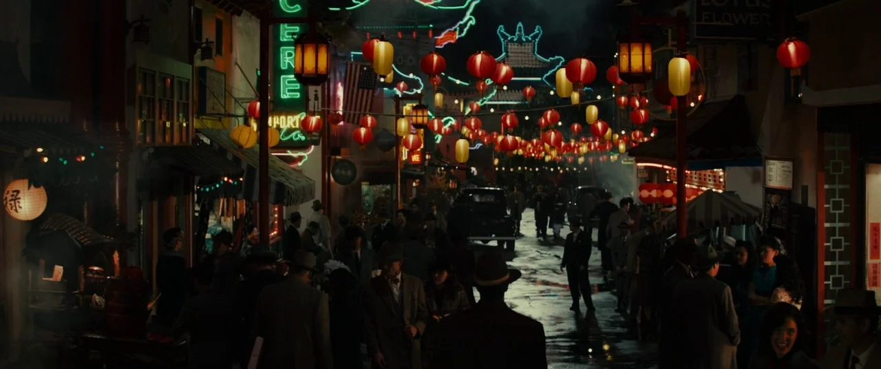 Gangster Squad (2013) movie still: wide — A crowded Chinatown street at night is illuminated by numerous red and yellow lanterns. Many people in…