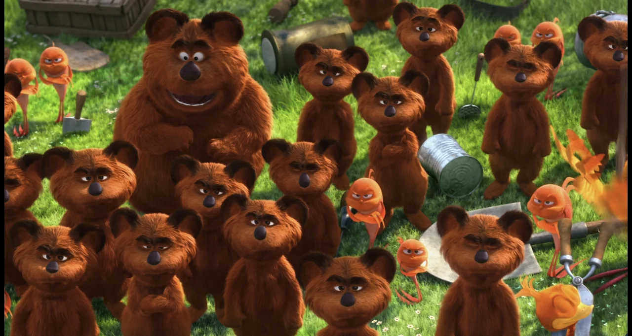 The Lorax (2012) movie still: wide — A grassy meadow serves as the setting for a gathering of brown bears. Many small, round orange creatures are…