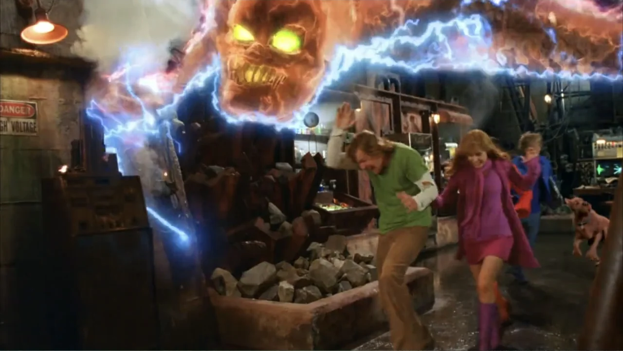 Scooby-Doo 2: Monsters Unleashed (2004) movie still: medium — An industrial lab setting features piles of rock debris and high-voltage warning…