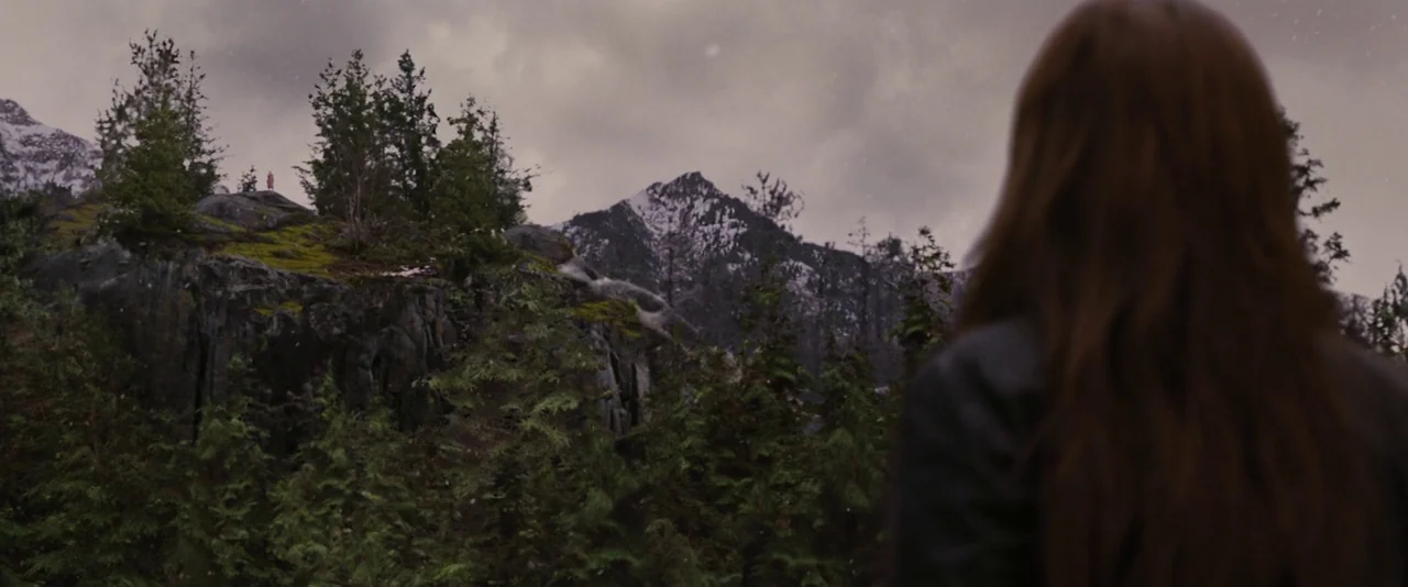 The Twilight Saga: Breaking Dawn – Part 2 (2012) movie still: wide — A rugged mountain landscape features steep cliffs covered in moss and evergreen…