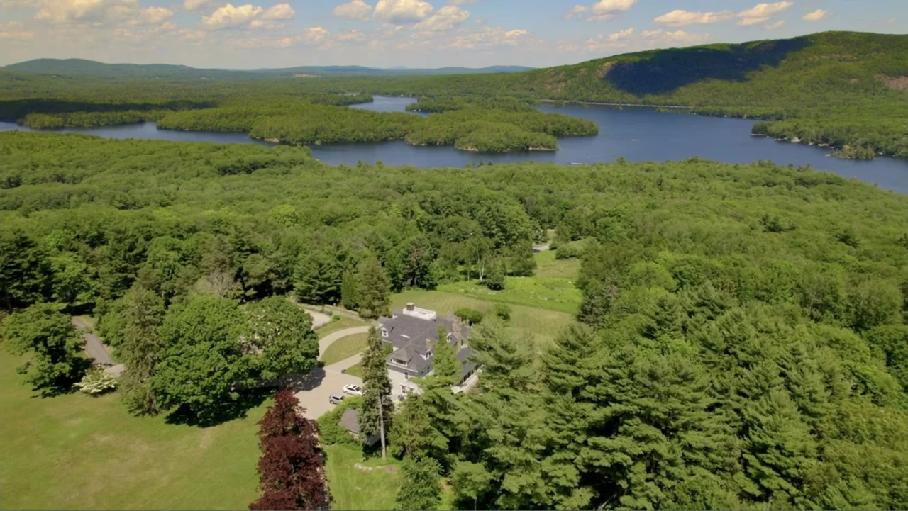 The Day the Music Died: The Story of Don McLean's "American Pie" (2022) movie still: establishing — A sprawling estate sits within a dense forest…