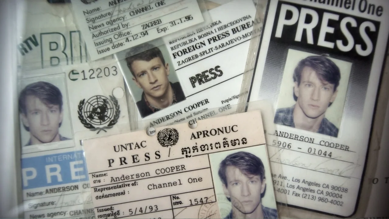 Nothing Left Unsaid: Gloria Vanderbilt & Anderson Cooper (2016) movie still: closeup — A cluster of overlapping 1990s press identification cards for…