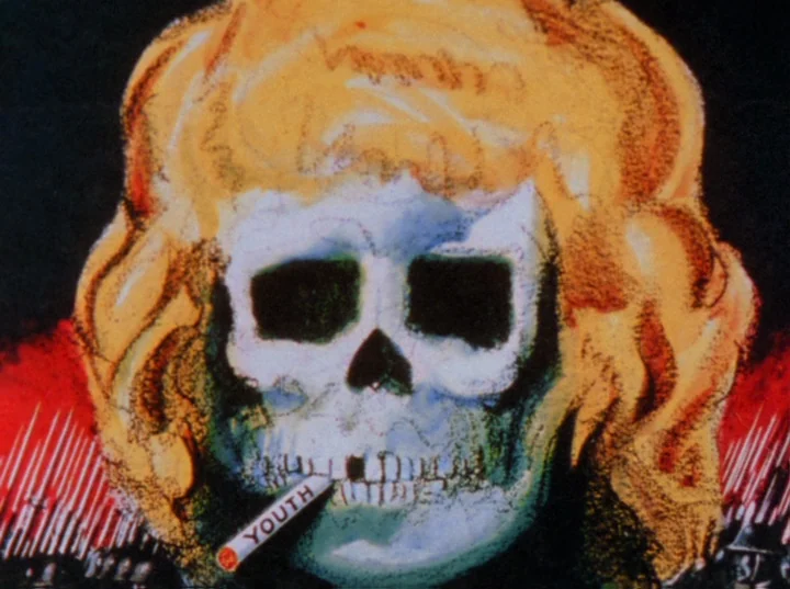 Scorpio Rising (1963) movie still: closeup — A stylized, hand-drawn image of a skull wearing a vibrant blonde wig. The skull holds a cigarette…