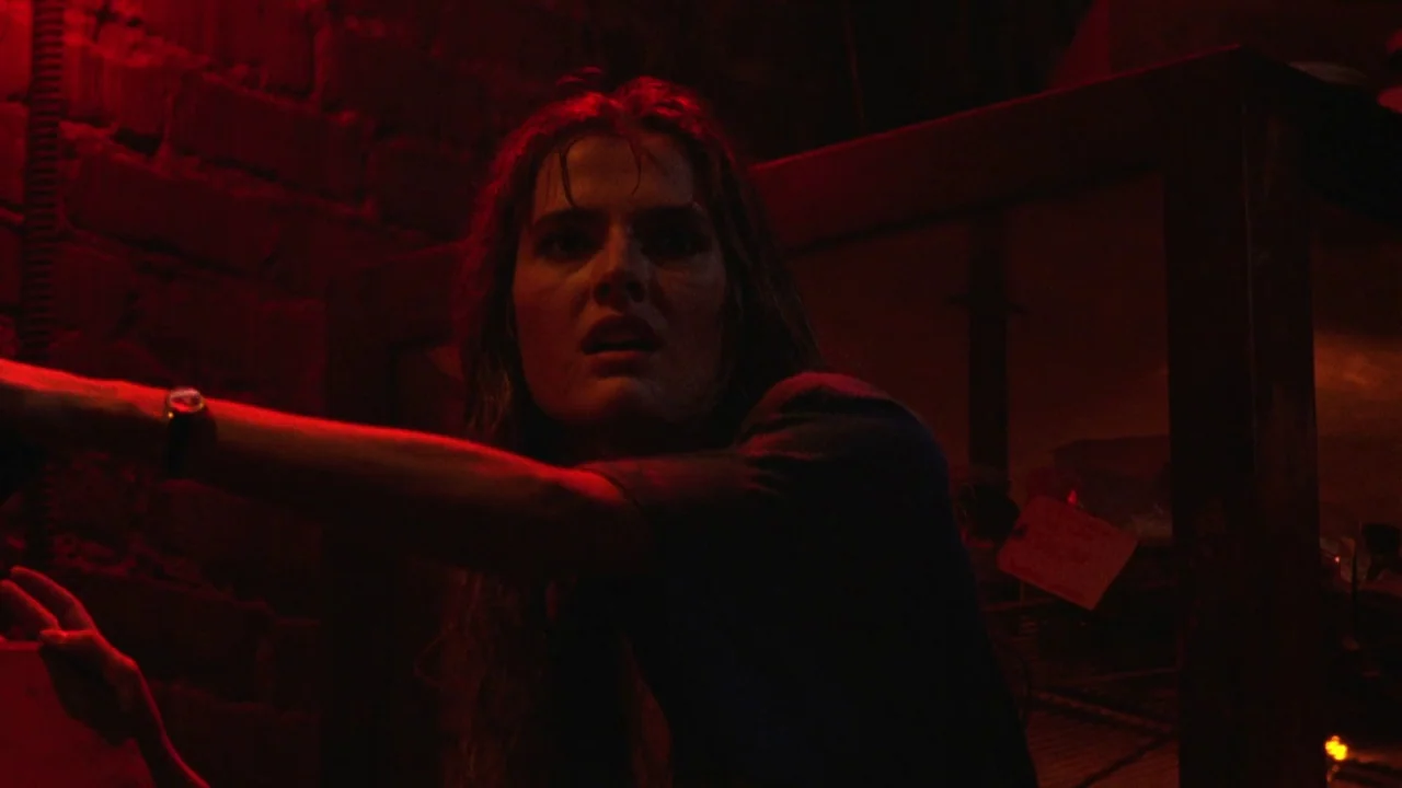 Bride of Reanimator (1989) movie still: medium — A dimly lit industrial basement featuring exposed dark brick walls and shadowy equipment racks. A…