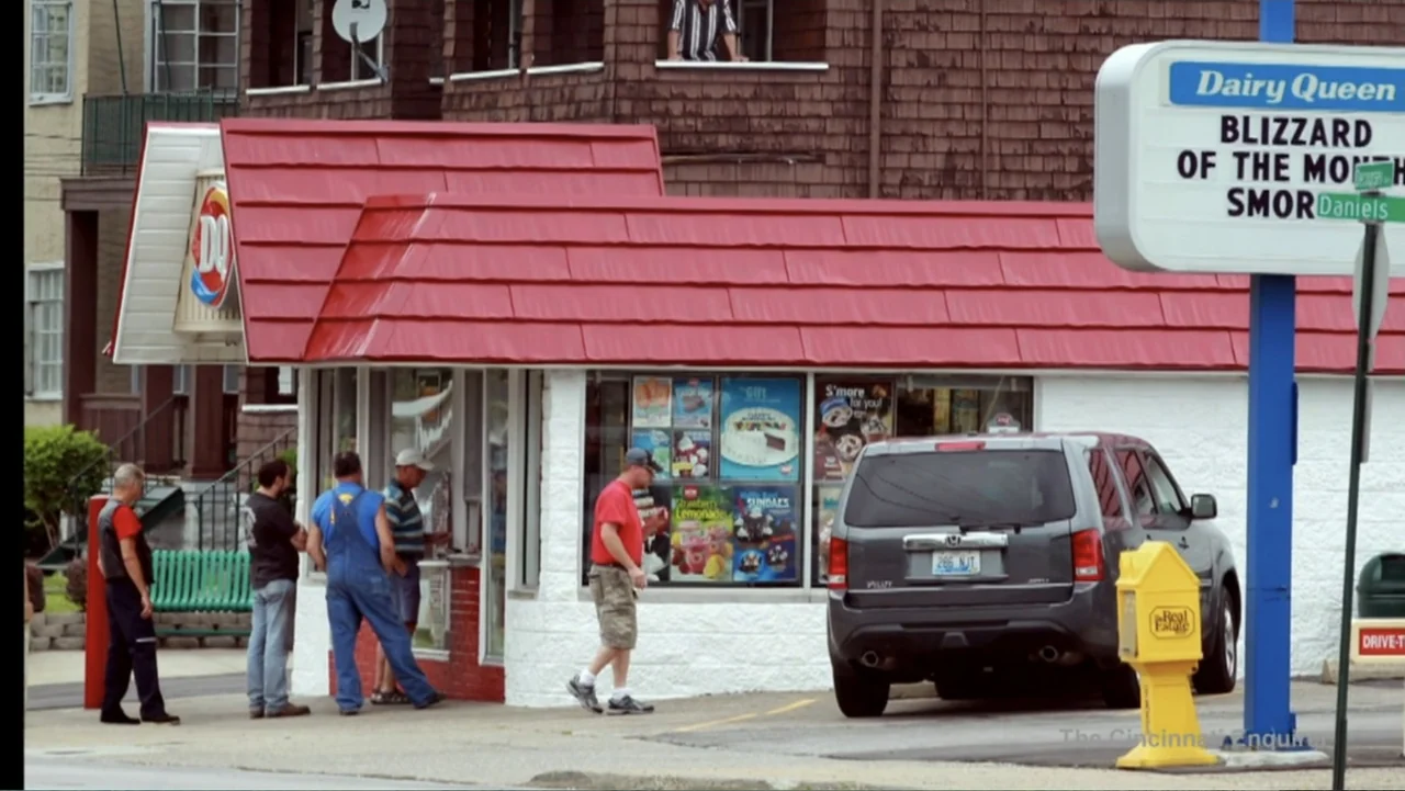 Requiem for the Dead: American Spring 2014 (2015) movie still: wide — A small Dairy Queen building with a red roof sits beside a gray SUV. Several…