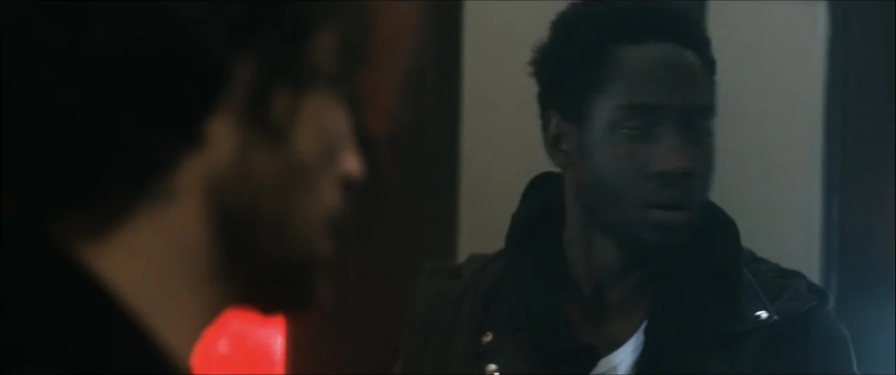 I'll Take Your Dead (2018) movie still: medium — A dark interior space features two men positioned in an over-the-shoulder framing. The subject on…