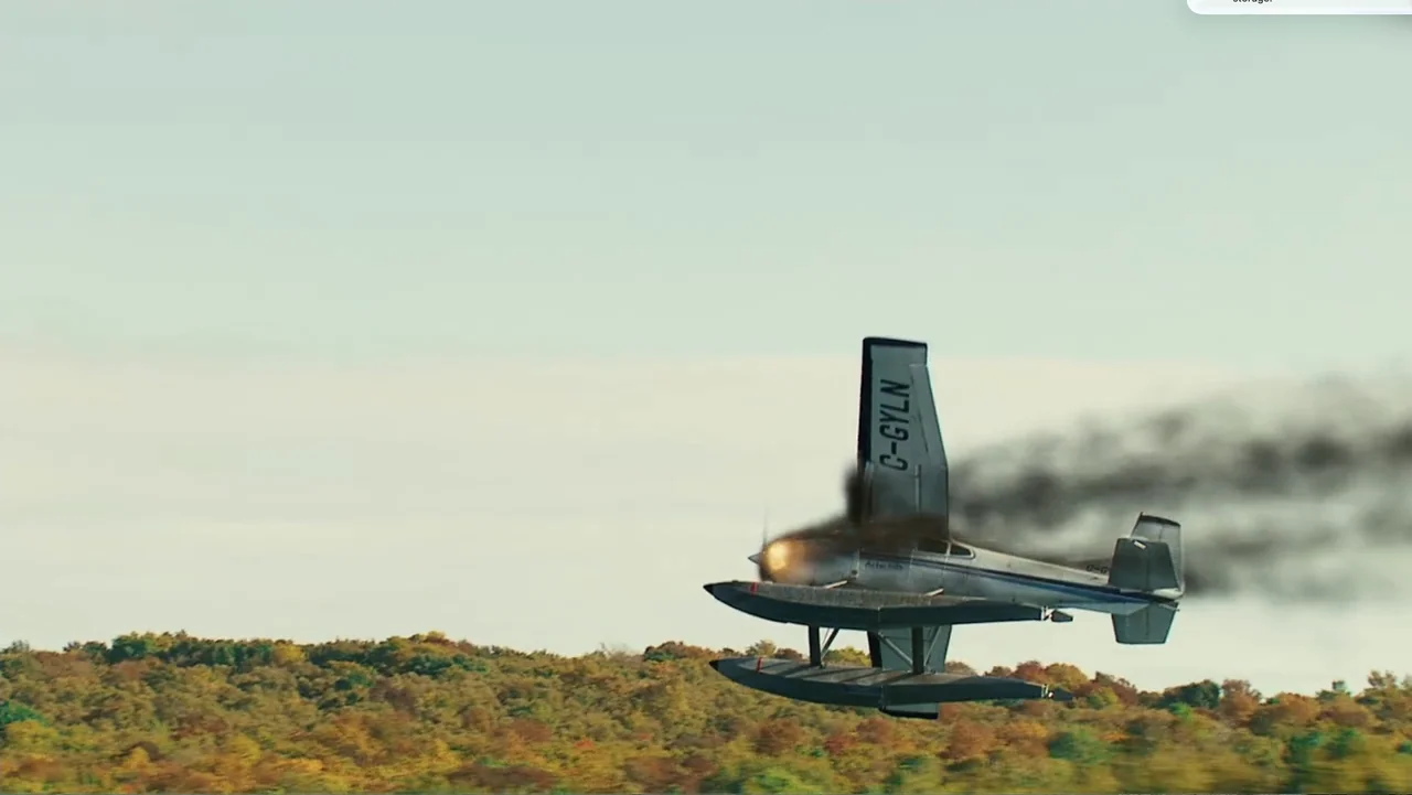 National Parks Adventure (2016) movie still: wide — A small silver floatplane flies over a dense autumn forest landscape. Thick black smoke billows…