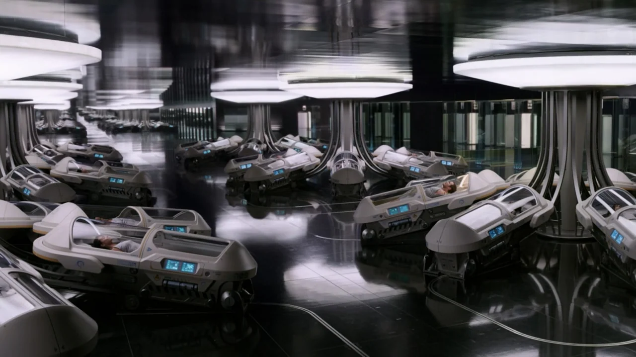 Passengers (2016) movie still: wide — A spacious futuristic hall filled with rows of sleek, white medical stasis pods. Humans lie asleep inside the…