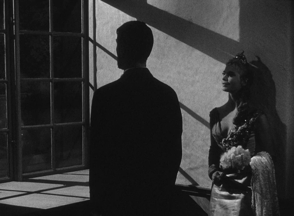 Smiles Of A Summer Night (1955) movie still: medium — An interior space features textured plaster walls and a large, multi-pane casement window. A…