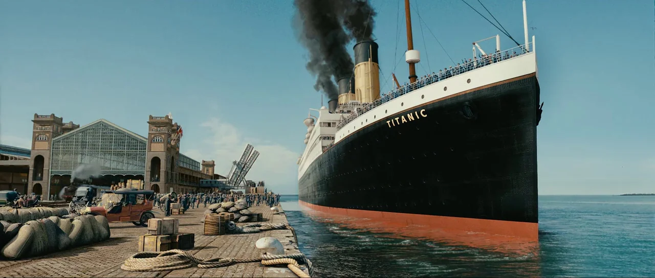 The Extraordinary Adventures of Adèle Blanc-Sec (2010) movie still: wide — A massive ocean liner is moored along a busy industrial wharf in early…