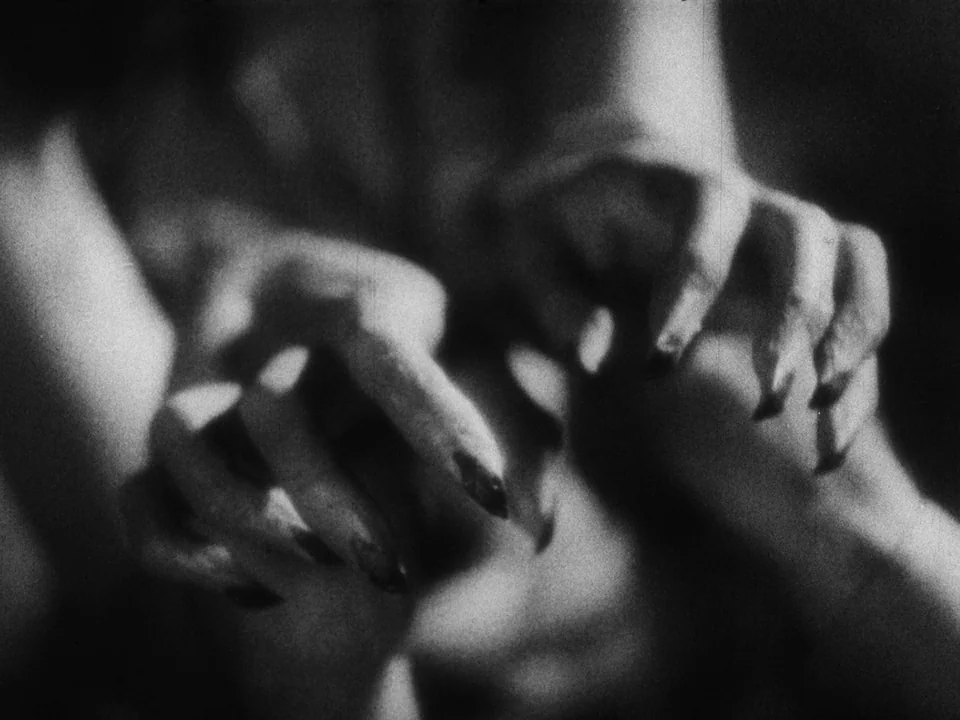 Island of Lost Souls (1932) movie still: closeup — A pair of human hands are held in a clawed, curled position against a background. The fingers are…