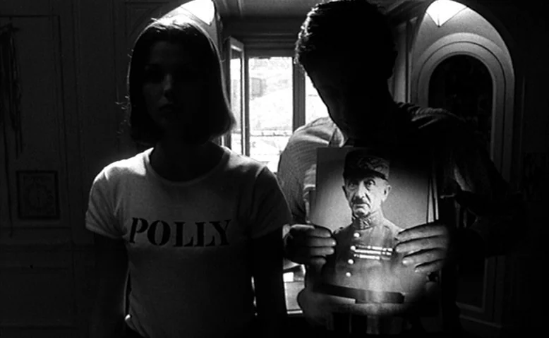 Who Are You, Polly Maggoo? (1966) movie still: medium — An interior space with a window in the background providing strong backlight illumination. A…
