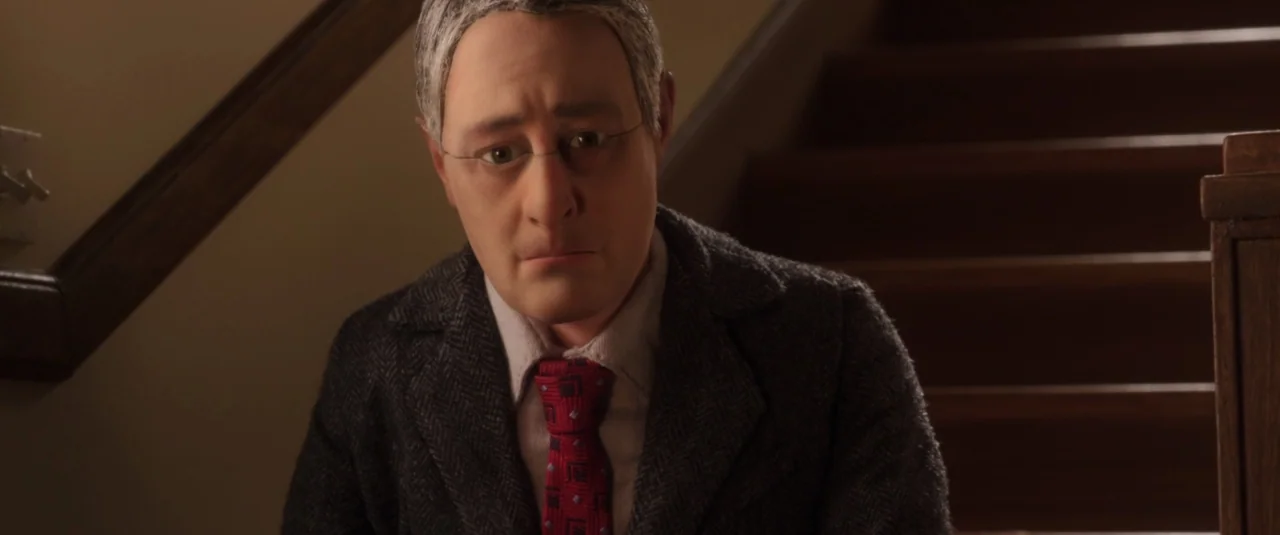 Anomalisa (2015) movie still: medium — A man stands near the base of wooden stairs in a dim interior space. The character wears a dark suit jacket…