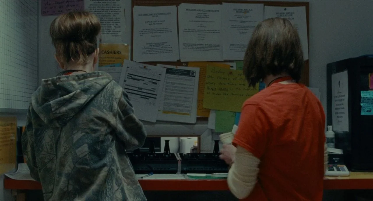 Never Rarely Sometimes Always (2020) movie still: medium — A service desk features a bulletin board covered with various notices and typed memos.…