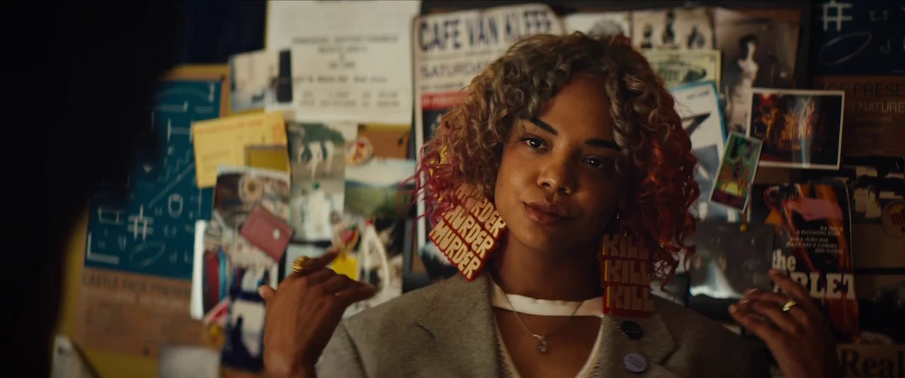 Sorry to Bother You (2018) movie still: medium — A cluttered wall covered in posters and notes provides a busy background for a person. A woman with…