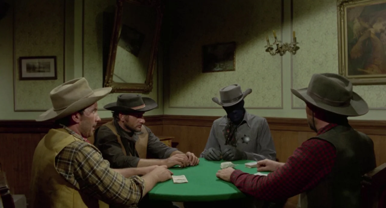 Johnny Colt (1966) movie still: medium — A dimly lit room with olive green wallpaper and framed paintings on the wall. Four men in period clothing…