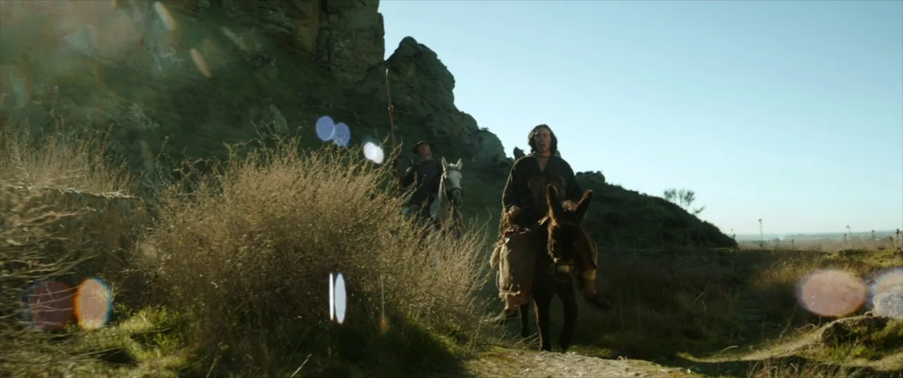 The Man Who Killed Don Quixote (2018) movie still: wide — A rugged, barren landscape featuring large rocky formations and sparse desert scrubland.…