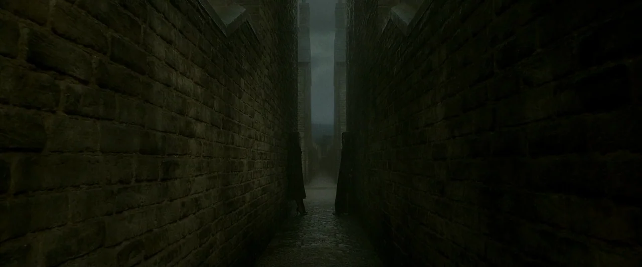 Harry Potter & The Half Blood Prince (2009) movie still: wide — A narrow stone alleyway is bounded by high, dark brick walls on both sides. Two…