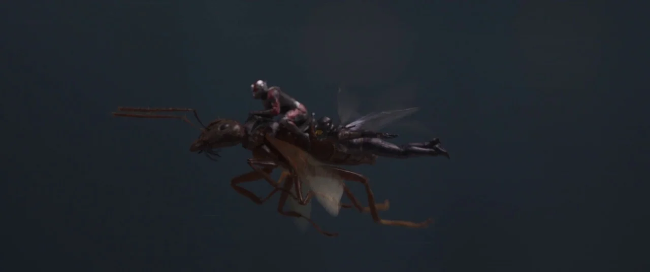 Ant-Man and the Wasp (2018) movie still: wide — A dark, empty space represents the night sky at high altitude. Two small figures ride on the back of…