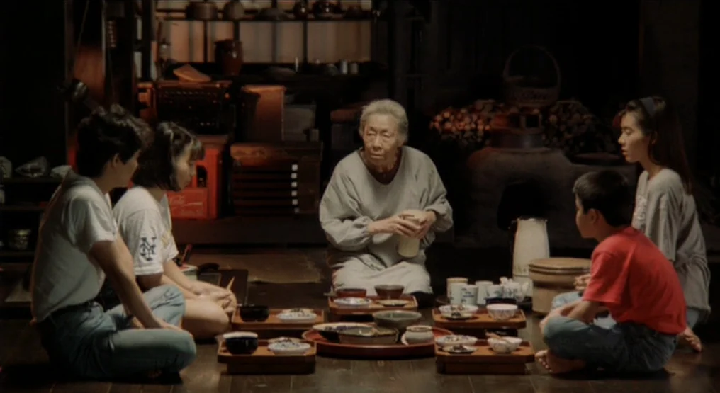 Rhapsody in August (1991) movie still: medium — A traditional Japanese room features dark wood flooring and antique furniture in the background. A…
