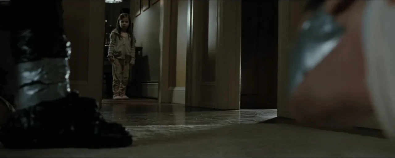 Law Abiding Citizen (2009) movie still: medium — A residential hallway at night features wooden door frames and wall-to-wall carpeting. A young…