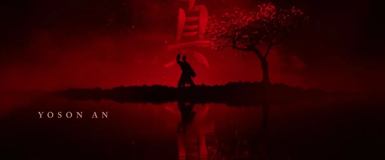 Mulan (2020) movie still: wide — A small isolated landmass sits in the center of a still, dark body of water. A silhouetted warrior stands on the…