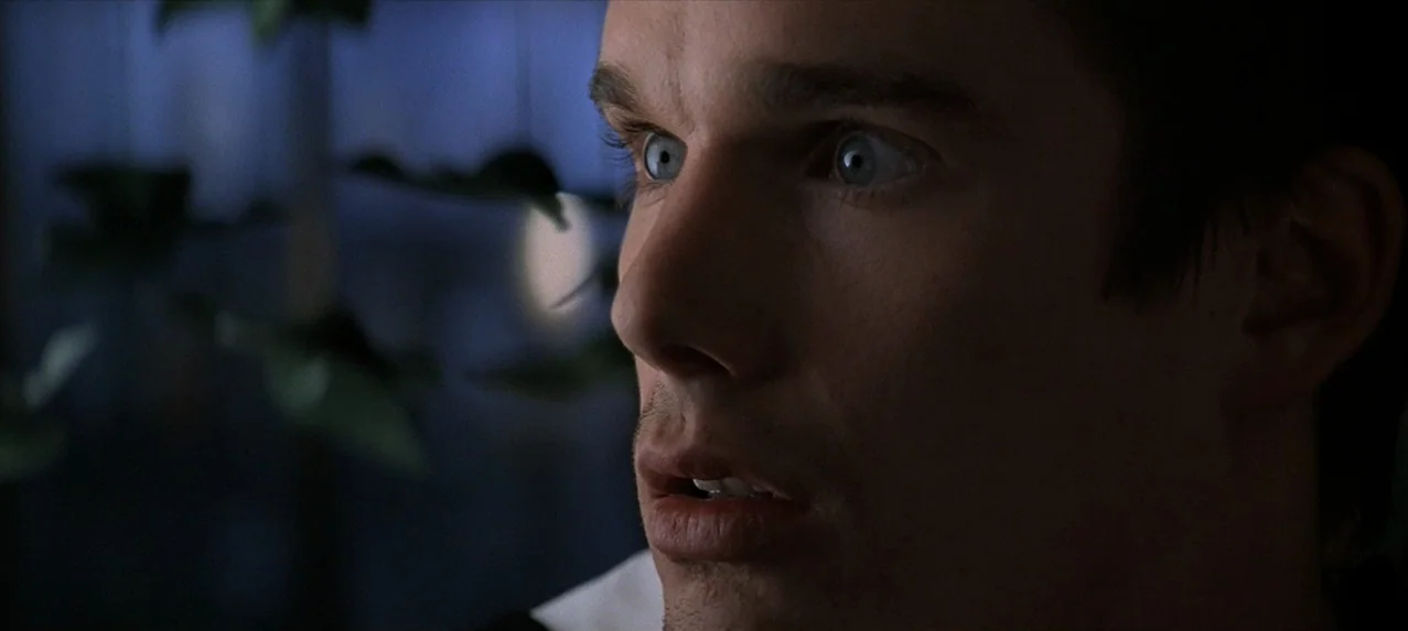 Great Expectations (1998) movie still: closeup — A dark indoor space at night is illuminated by cool light from a window. A young man with light…