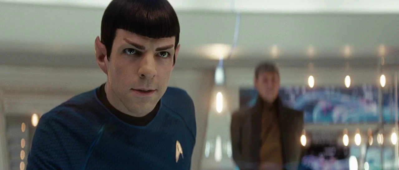 Star Trek (2009) movie still: medium — A sterile, futuristic environment with metallic surfaces and softly glowing lights in the background. A man…