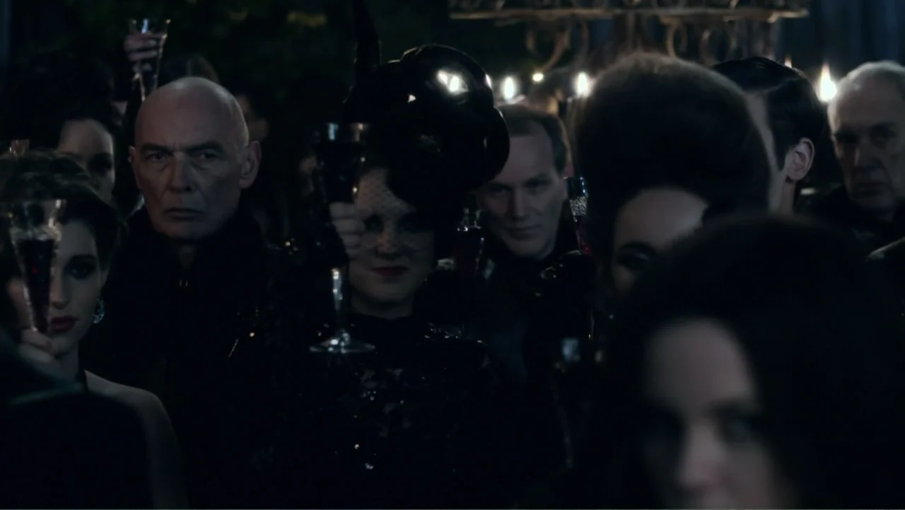 Underworld: Blood Wars (2016) movie still: medium — A dark, crowded indoor space filled with individuals dressed in formal black attire. Attendees…