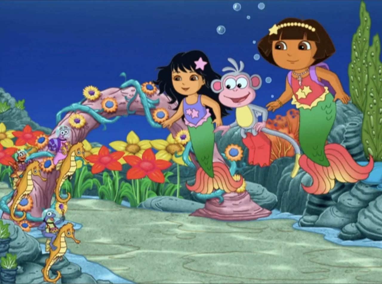 Dora the Explorer: Mermaid Adventures (2025) movie still: medium — An underwater scene features colorful coral and stylized seaweed on a sandy…