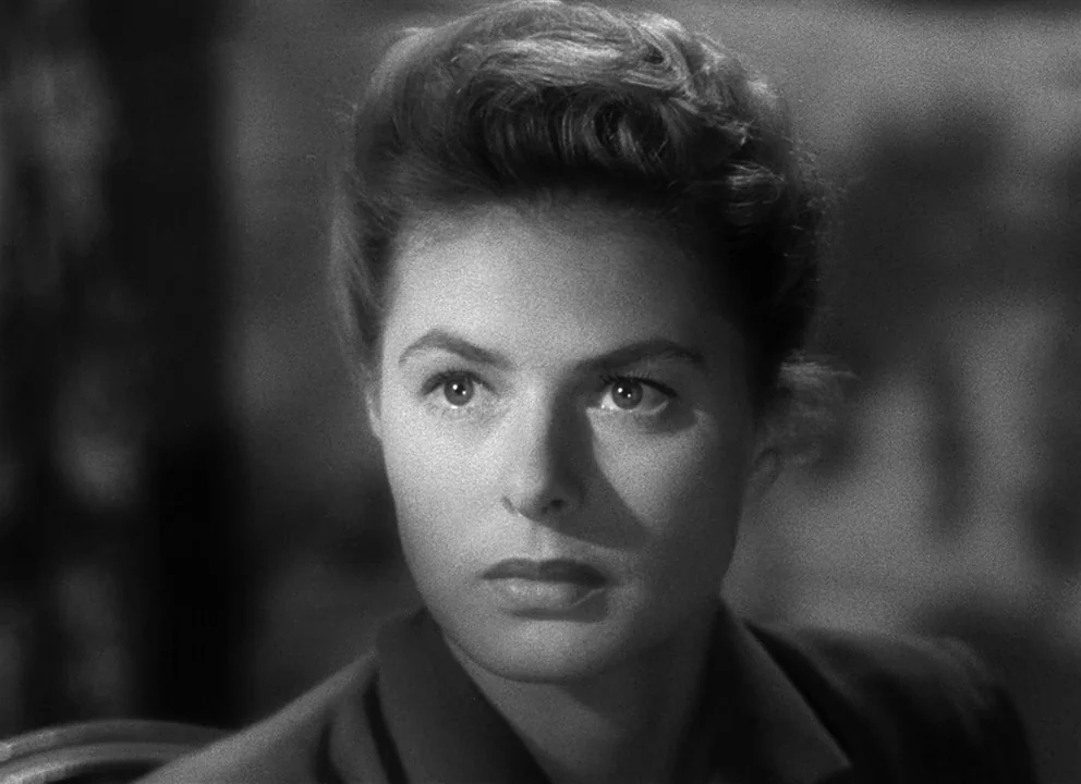 Spellbound (1945) movie still: closeup — A dimly lit indoor space with indistinct textures visible in the blurred background. A woman looks…