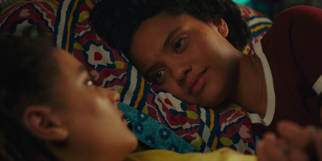 Hearts Beat Loud (2018) movie still: closeup — Two women lie side by side on a patterned fabric pillowcase in a room. They look at each other while…
