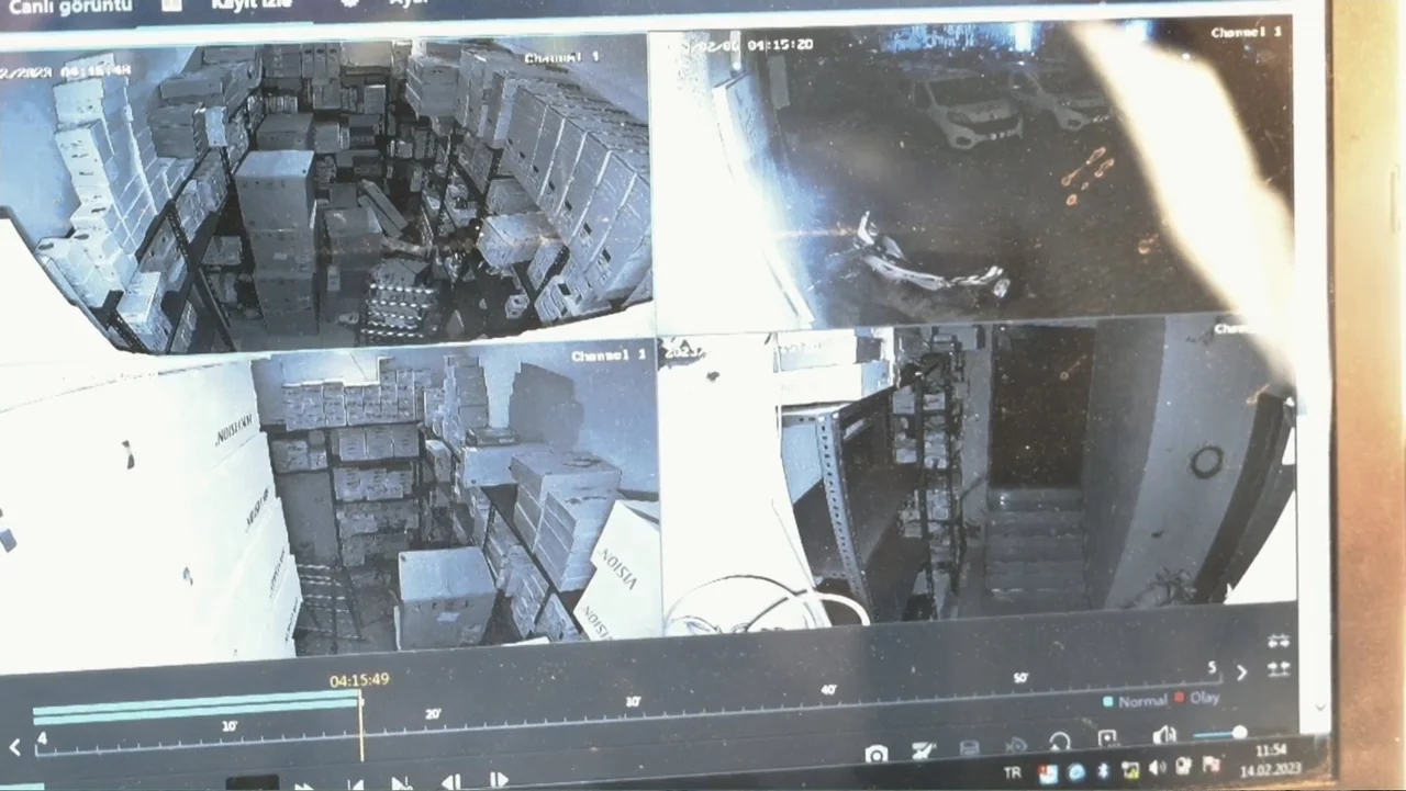 Death Without Mercy (2024) movie still: establishing — A dark warehouse interior is filled with stacked cardboard boxes on metal shelving units.…