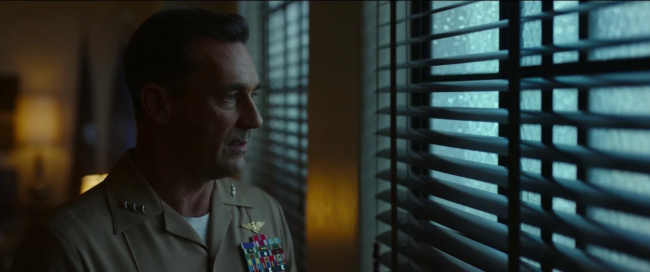 Top Gun: Maverick (2022) movie still: medium — An interior space is illuminated by cool light filtering through closed window horizontal blinds. A…