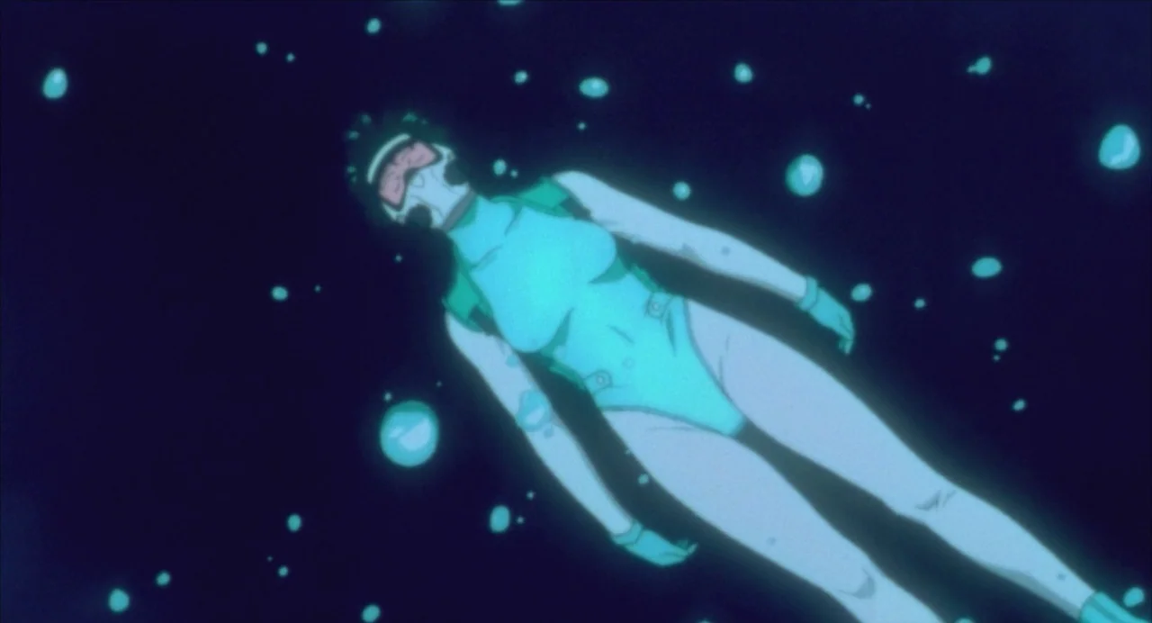 Ghost in the Shell (1995) movie still: fullbody — A diver floats suspended in the dark, deep water of an ocean. Numerous air bubbles drift upward…