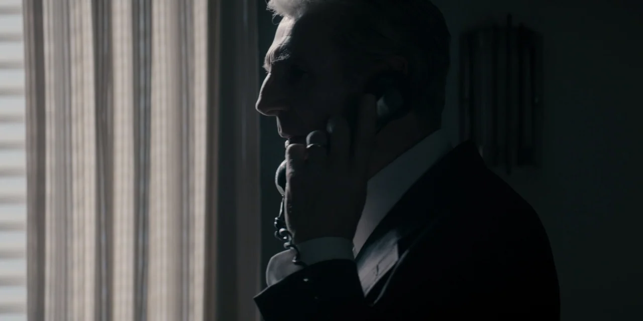 Mark Felt: The Man Who Brought Down the White House (2017) movie still: closeup — An interior office space features dark walls and a window with…