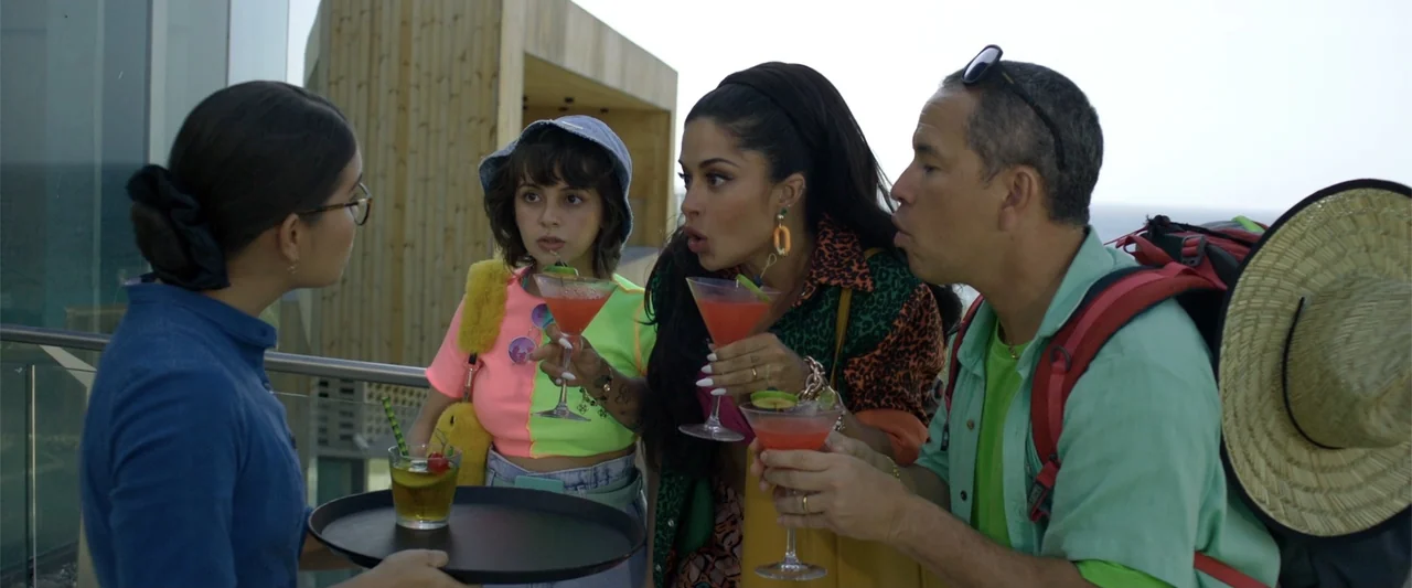Férias Trocadas (2024) movie still: medium — An outdoor balcony with modern wooden architectural elements overlooks the sea under overcast skies.…