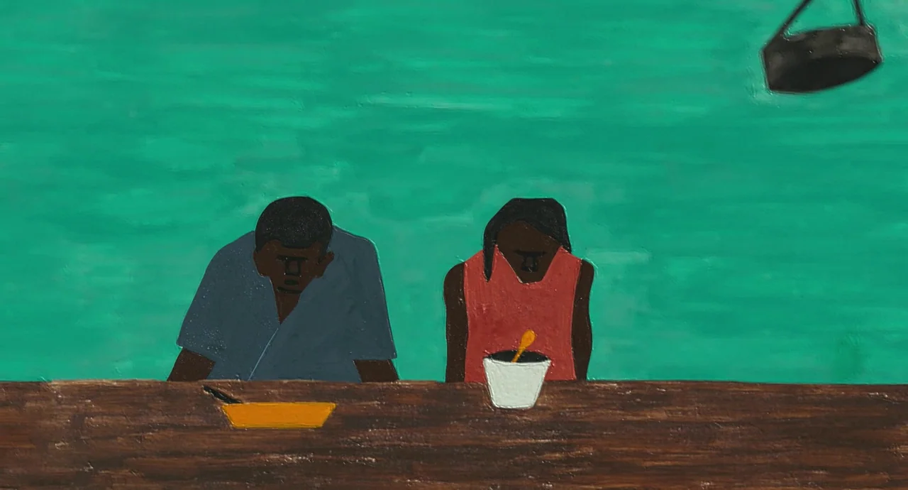 Detroit (2017) movie still: medium — A painted scene shows two people sitting at a wooden table against a turquoise wall. A man in a blue shirt and…