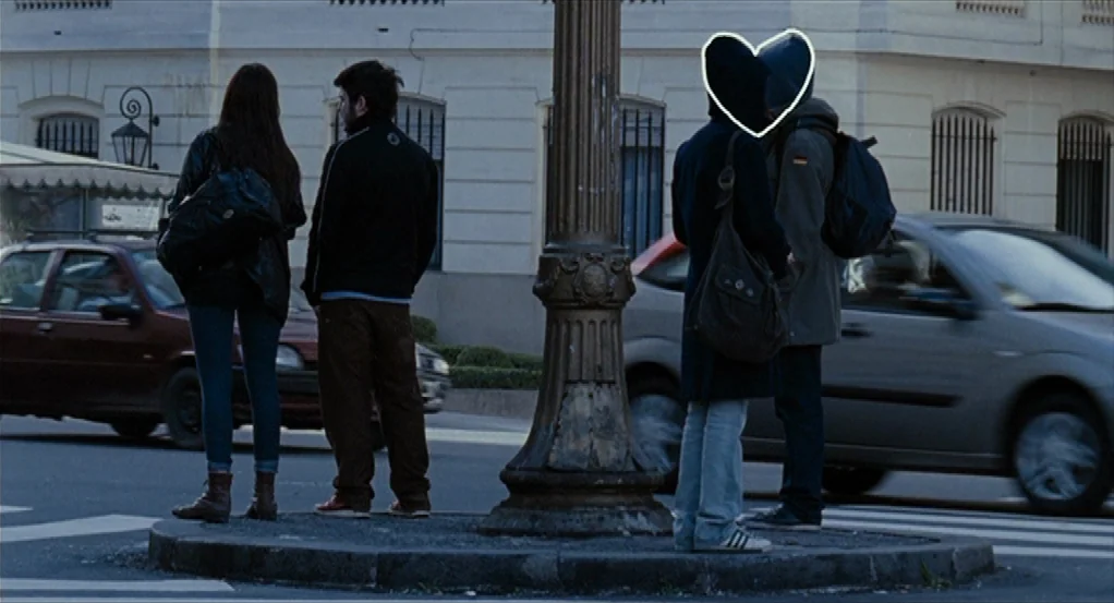 Sidewalls (2011) movie still: fullbody — Four people stand on a concrete traffic island at an urban intersection during daytime. They wait while…