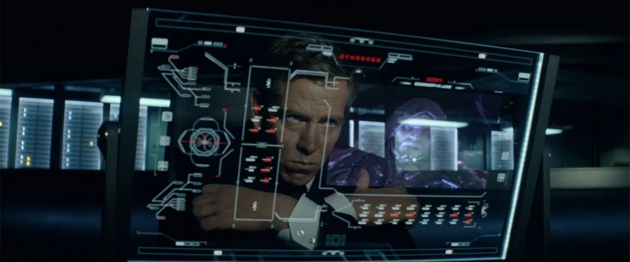 Ready Player One (2018) movie still: medium — A dark tech-filled room features a man looking through a glass monitor. Digital red and white data…