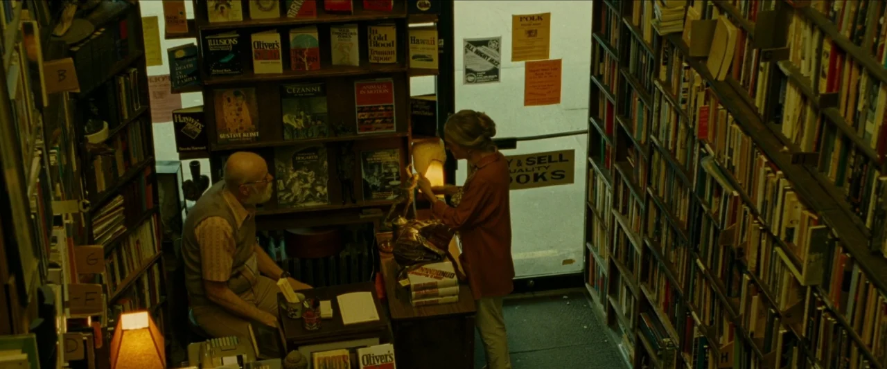 Wonderstruck (2017) movie still: wide — A narrow cramped store interior features floor-to-ceiling shelves packed with various paperback books. An…