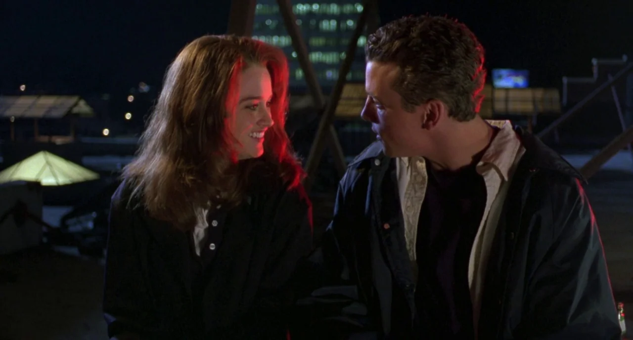 The Craft (1996) movie still: medium — A flat urban roof at night features structural scaffolding visible against a dark city background. A man and…