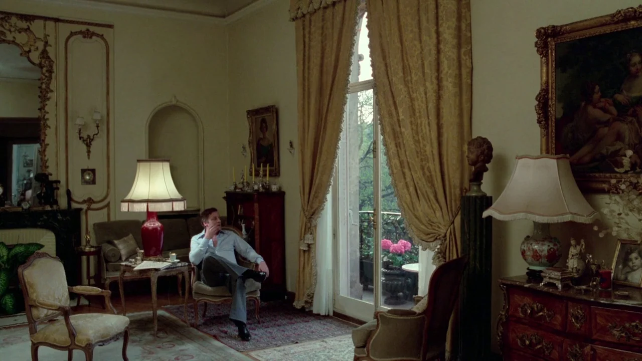 Sorcerer (1977) movie still: wide — A refined, high-ceilinged room features antique furniture, ornate gold-framed paintings, and heavy mustard…