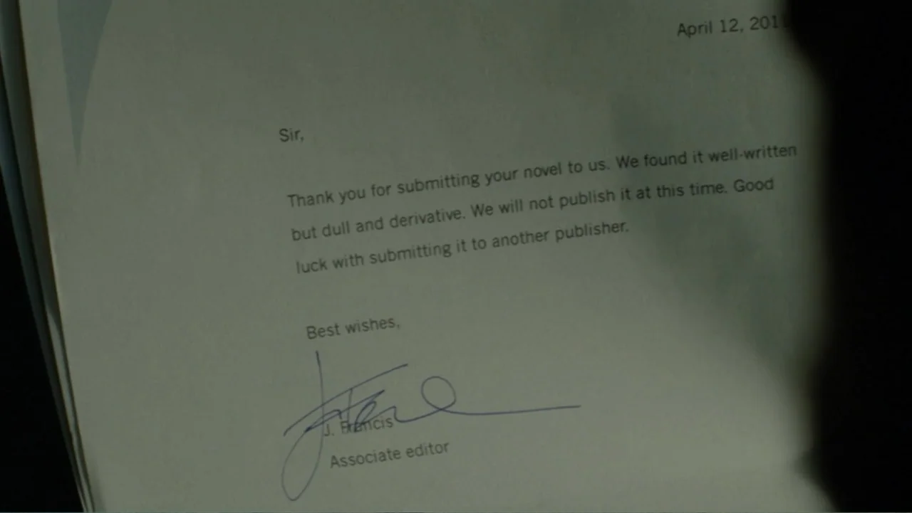 The Words (2012) movie still: closeup — A close-up view of a printed letter on off-white paper. The document includes formal text regarding a…