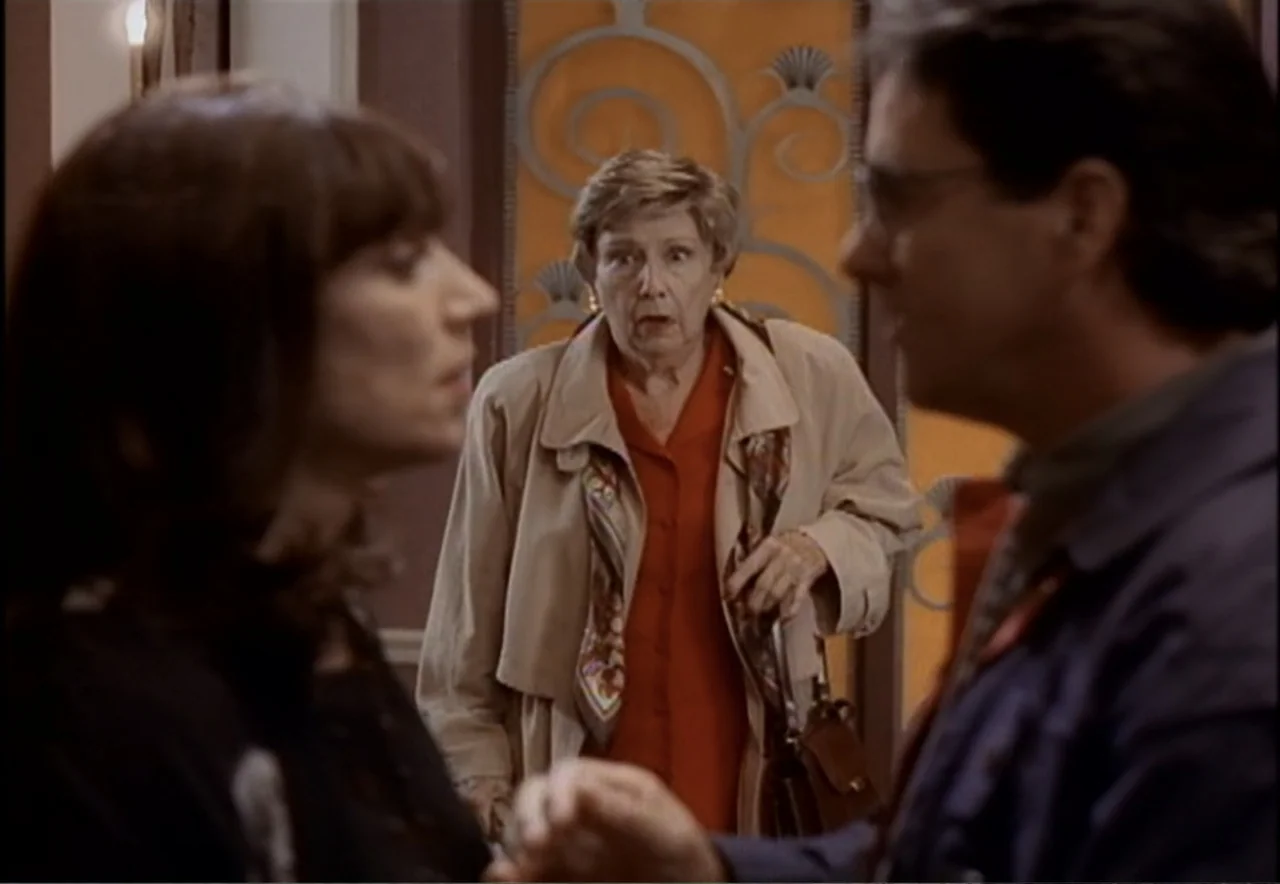 Chance of a Lifetime (1998) movie still: medium — An interior hallway leads into a room where an older woman stands in the entrance. A man and woman…