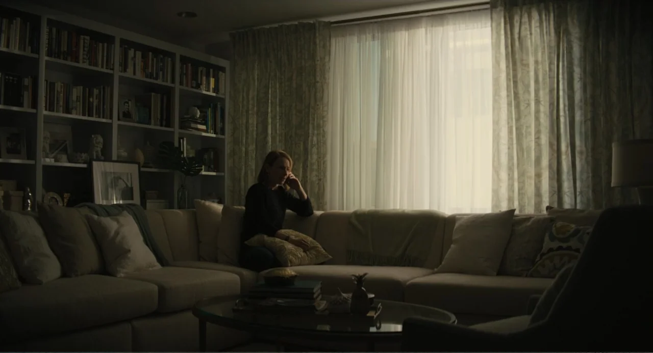 Beautiful Boy (2011) movie still: medium — A modern living room features a large sectional sofa and floor-to-ceiling bookshelves.