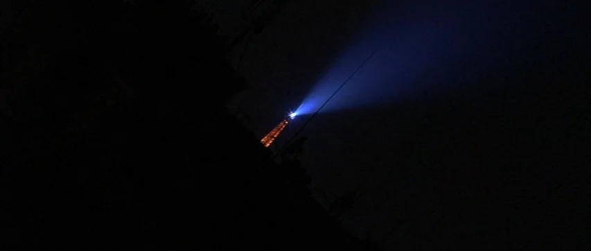 The Truth About Charlie (2002) movie still: wide — The night sky is dominated by pitch black darkness and silhouettes of dark foreground structures.…