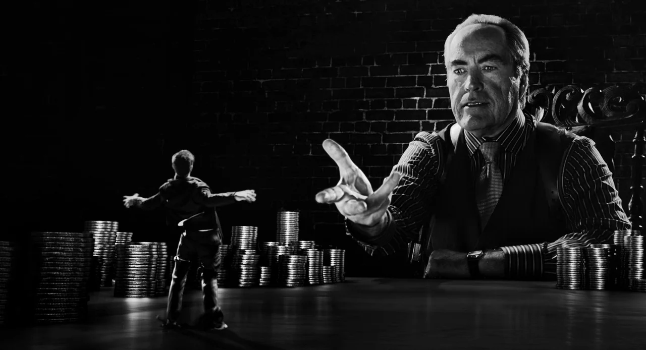 Sin City: A Dame to Kill For (2014) movie still: wide — A dark space with black brick walls is filled with large stacks of coins. A giant man looms…